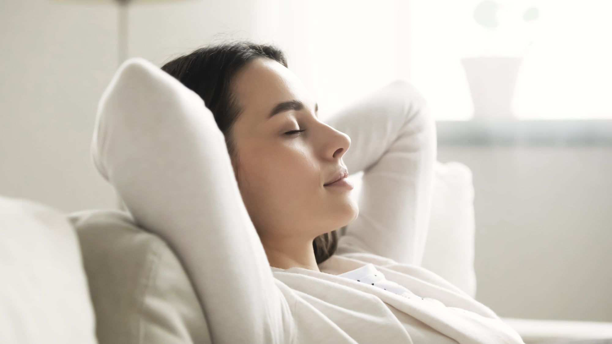 A woman resting on a sofa at home